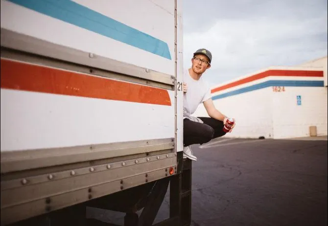 Worker resting in a refrigerated produce trailer at a loading dock
